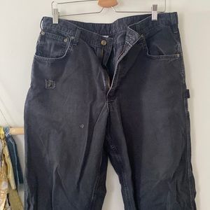 Faded black carhartt carpenter pants. Light wear and tear but still fashionable
